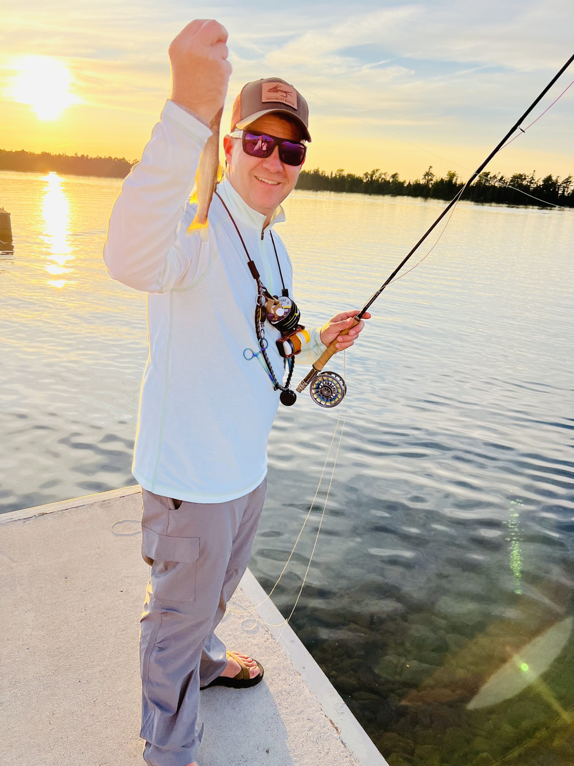 Tyler holding up the first trout of the trip