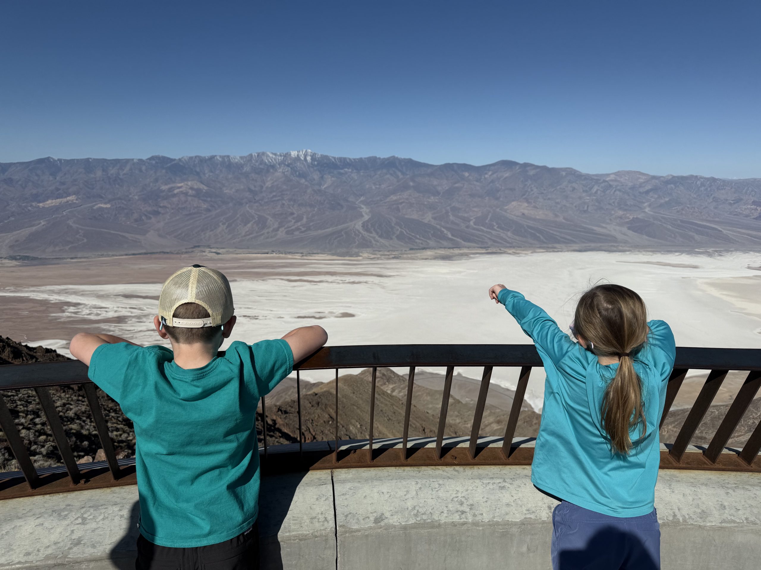 Two children overlooking the salt flats of Badwater Basin from Dante's Point
