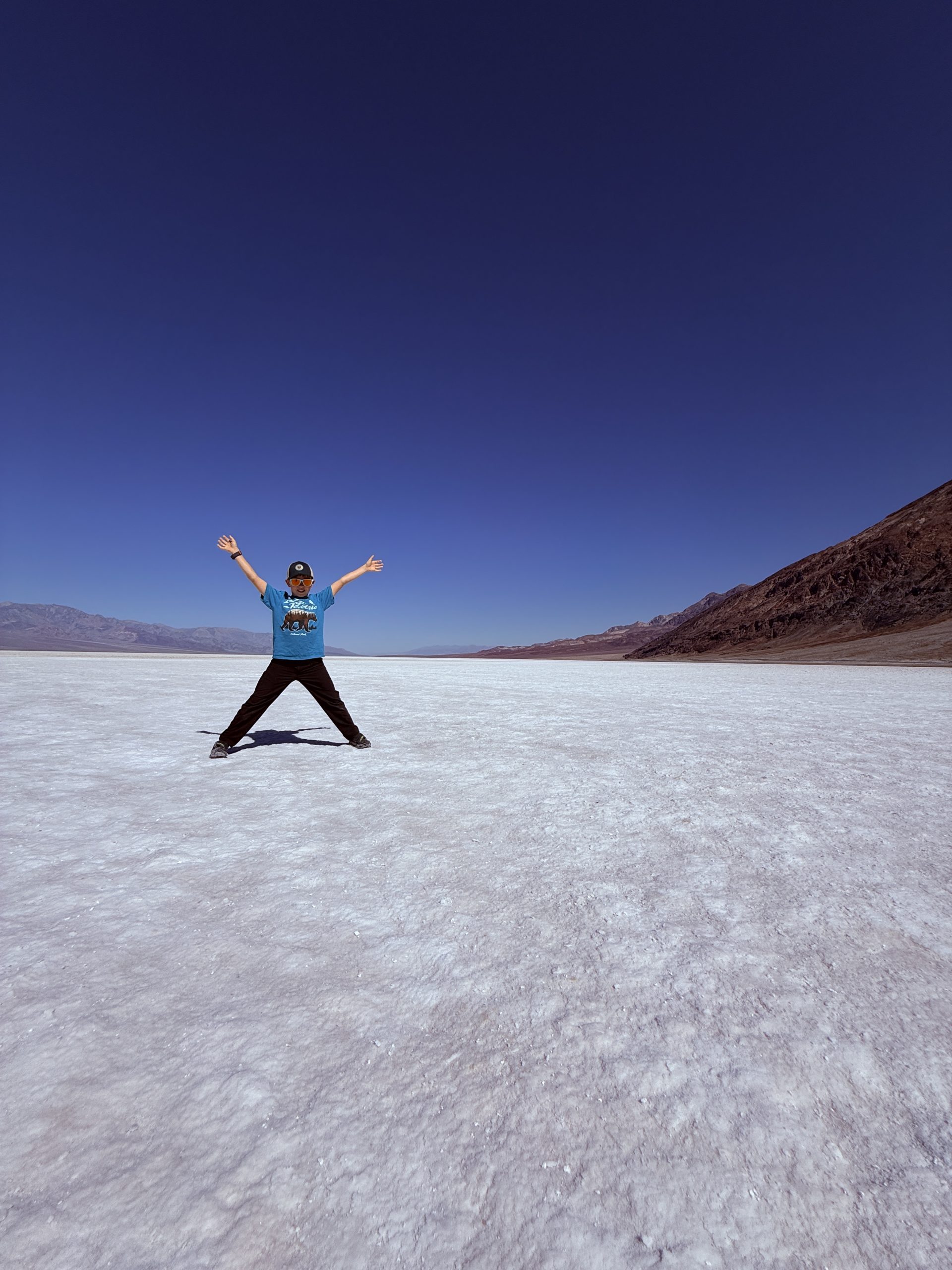 child standing on salt flat in Badwater Basin