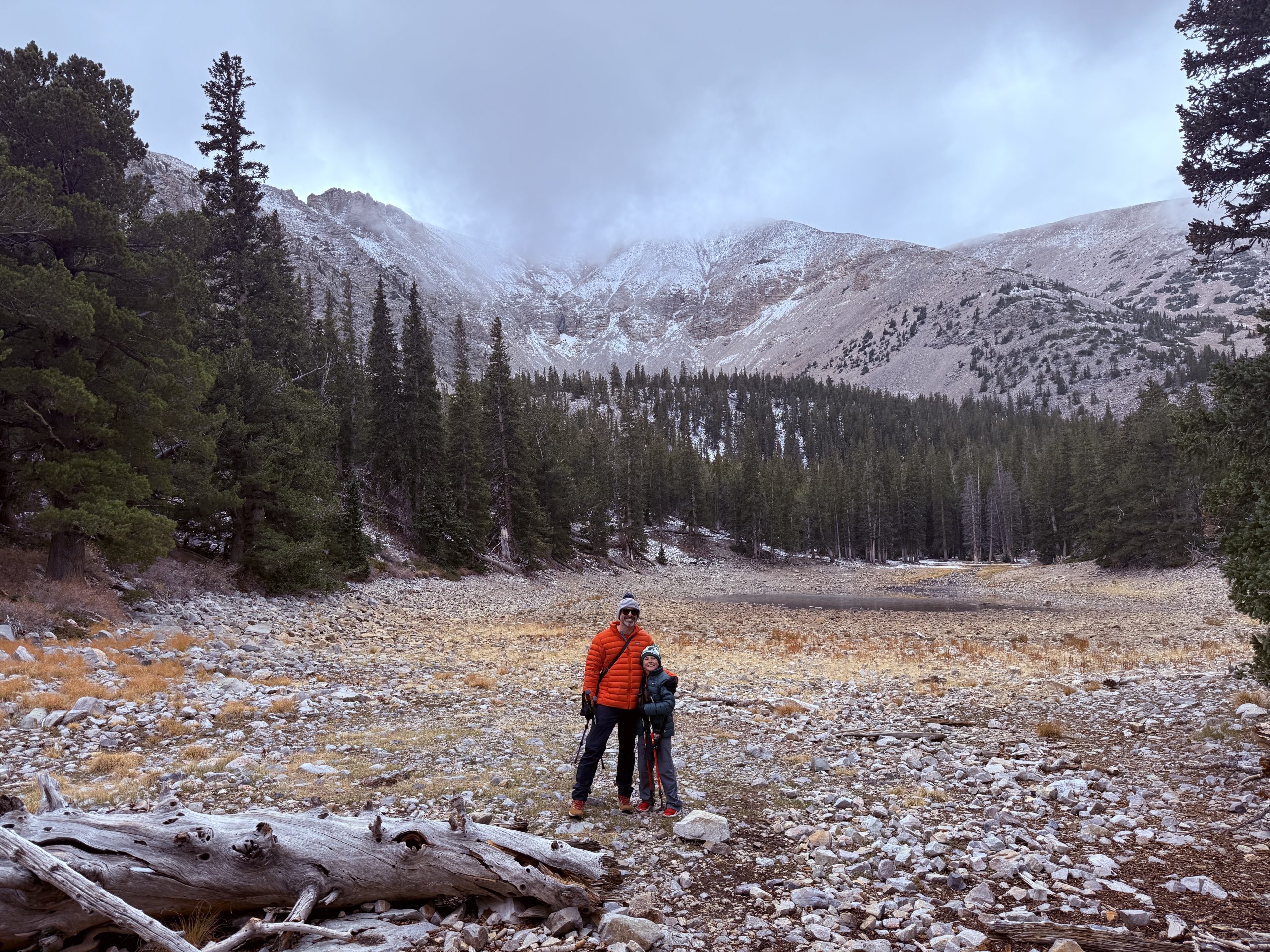 Father and son standing near an alpine lake in Great Basin National Park