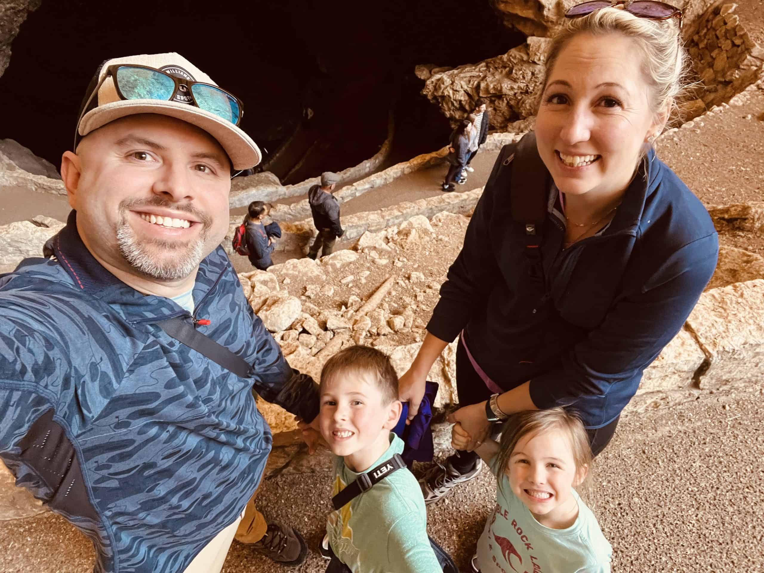 Two parents and kids at the mouth of the natural entrance at Carlsbad Caverns National Park