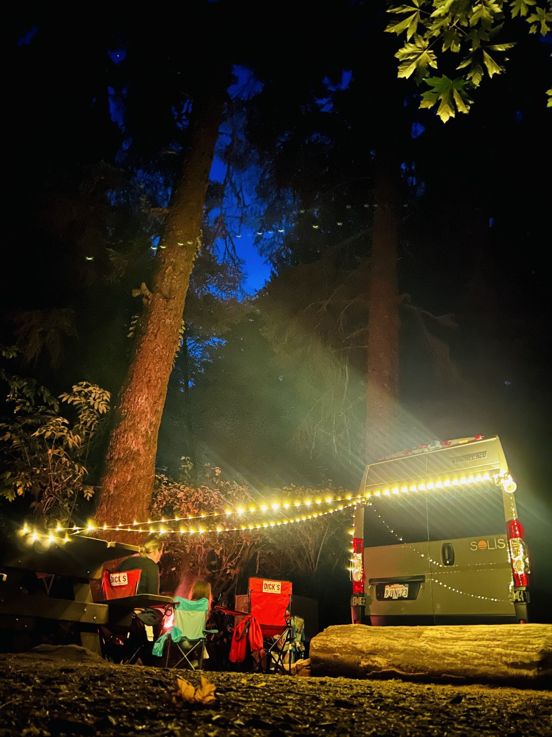 Camper van at night with solar string lights