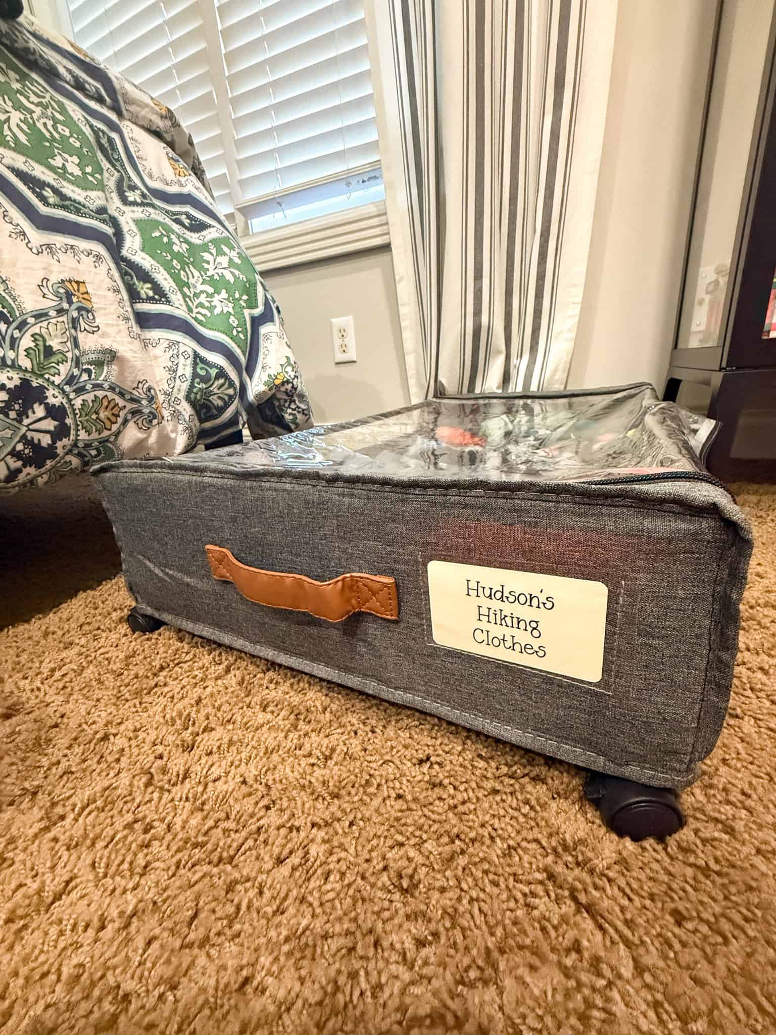 Labeled storage cube for family vacation organization system