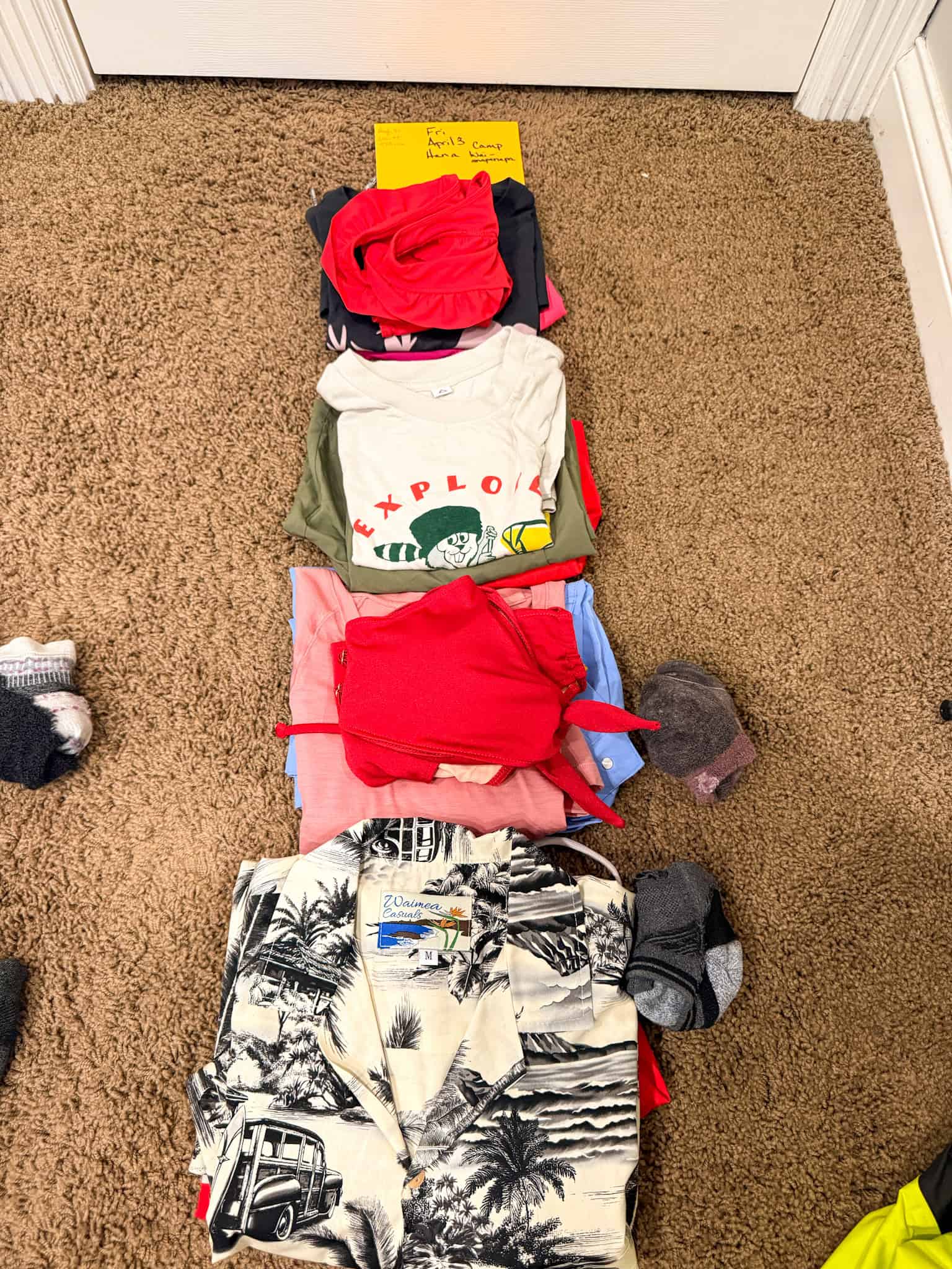 One day of clothes for four people packed together using day-by-day family packing system